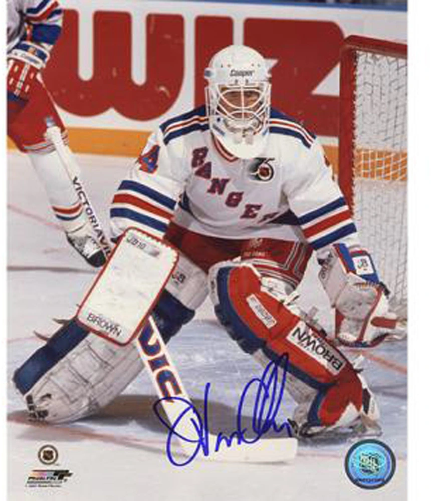 John VanBiesbrouck in a New York Rangers goaltending pose during an on-ice hockey action photo.